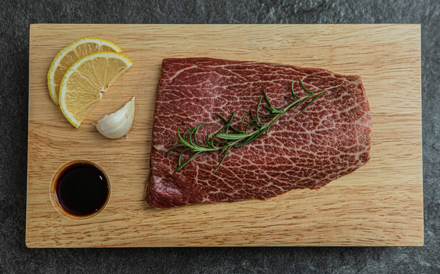 Kosher Wagyu Flat Iron Steak with lemon, garlic, rosemary and soy sauce. 