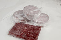 Frozen Kosher Wagyu Burgers and Ground Beef on a Marble Countertop available at Chu's Meat Market. 