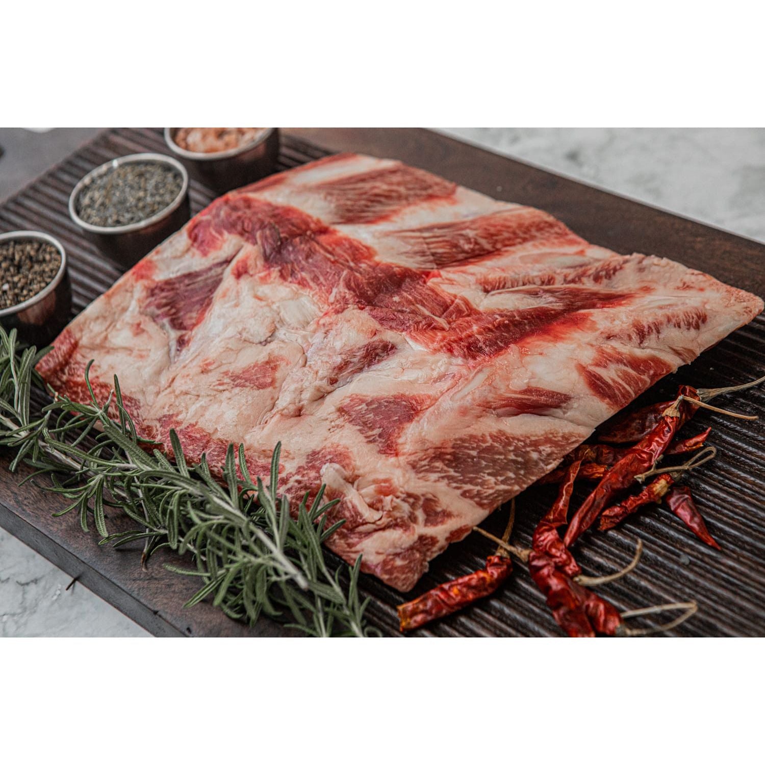 Kosher Fullblood American Wagyu back ribs displayed on a sleek marble countertop.