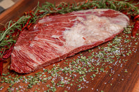 Kosher Wagyu Lifter Meat on a board with Spices. 
